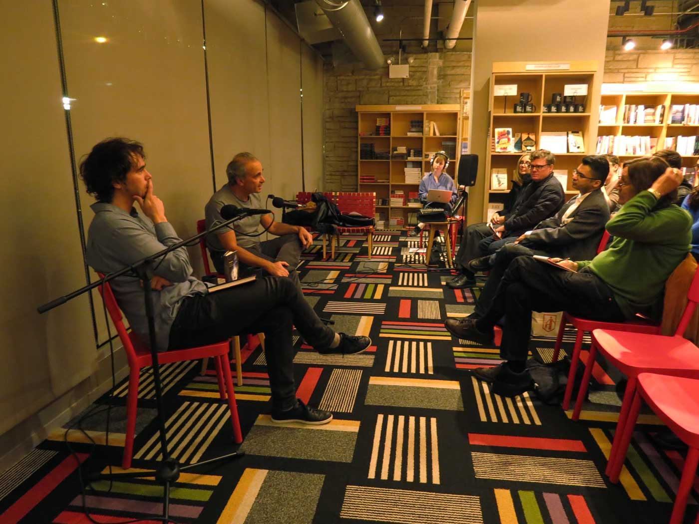 Author Michael Feher and panelist Jonathan Levy sit addressing a seated audience