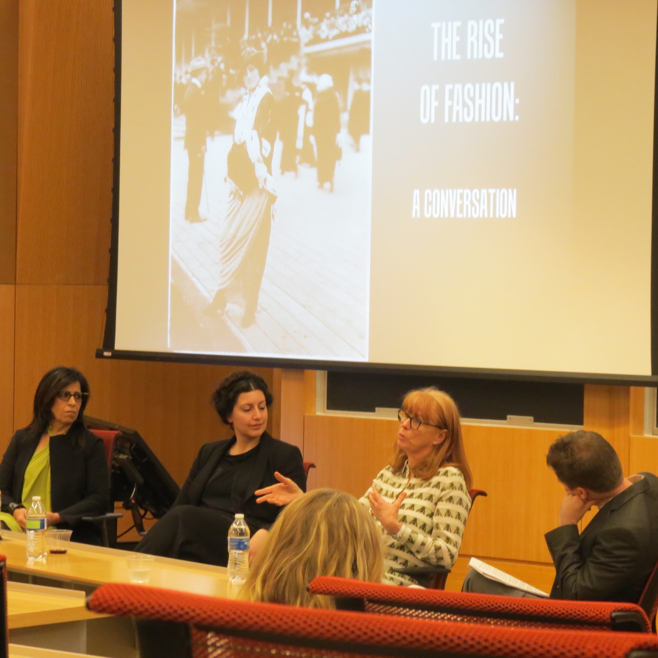 four panelists in conversation with audience in foreground