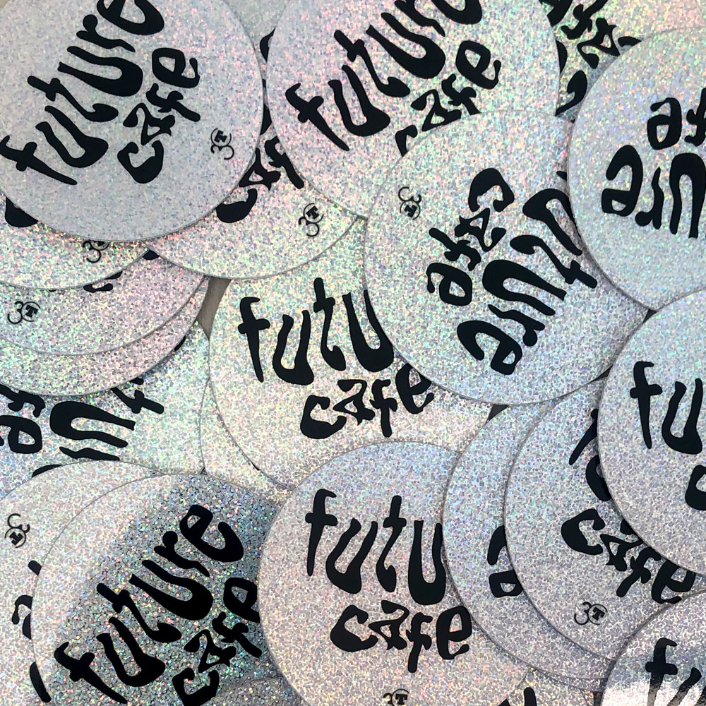 messy pile of circular, sparkly stickers that say Future Cafe